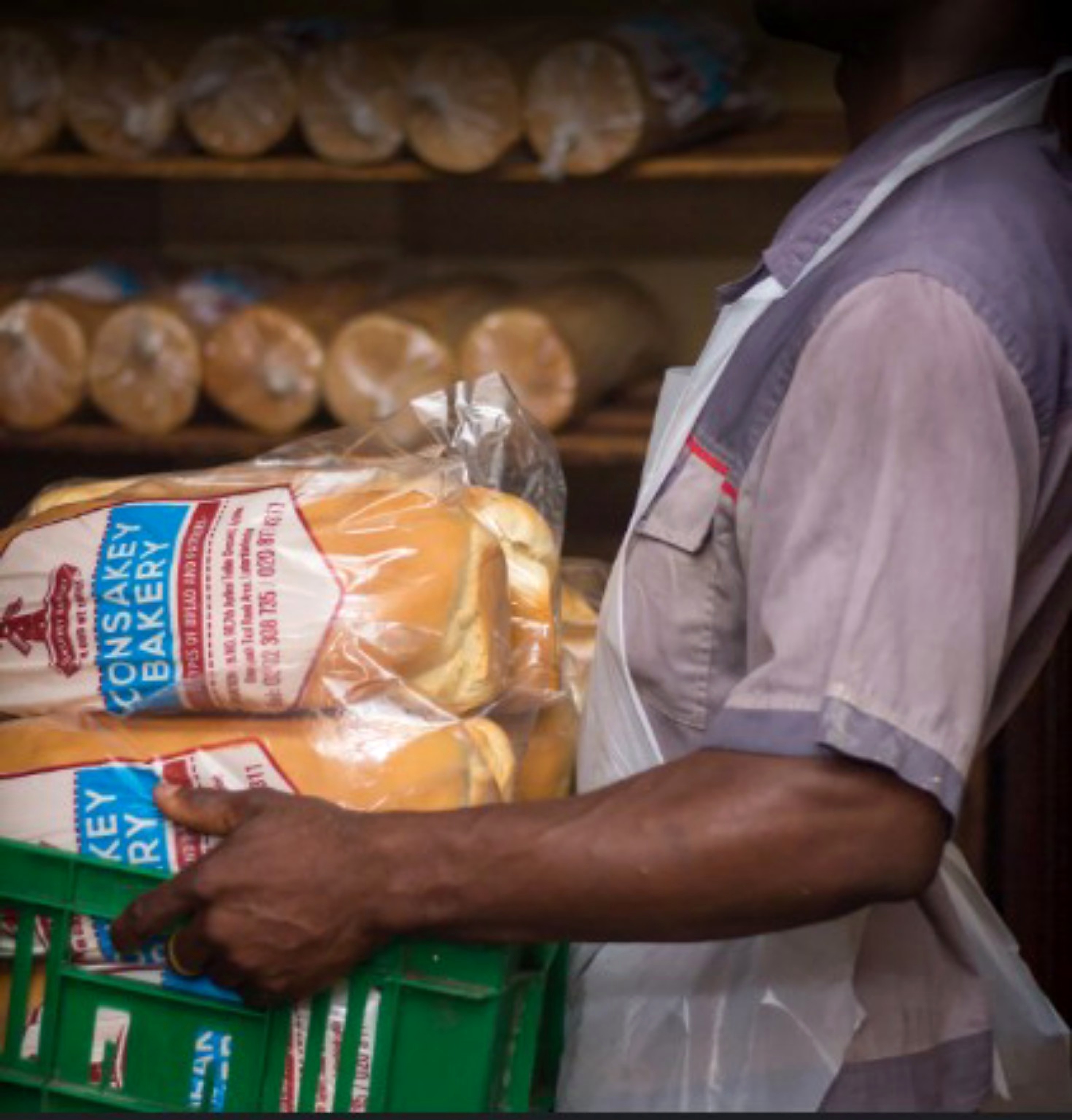 A Consakey Bakery team member preparing bread for customers